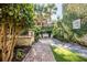 Landscaped backyard with brick pathway and seating area at 99 Tradd St, Charleston, SC 29401