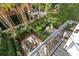 Elevated view of a landscaped backyard with patio furniture and palm trees at 99 Tradd St, Charleston, SC 29401
