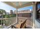 Wooden bench on a balcony overlooking the backyard at 99 Tradd St, Charleston, SC 29401