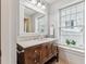 Vanity with a marble countertop and a large mirror at 99 Tradd St, Charleston, SC 29401