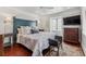Bedroom with hardwood floors, a dark-blue headboard, and a flat-screen TV at 99 Tradd St, Charleston, SC 29401