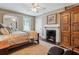 Bright bedroom with fireplace and built-in wooden cabinet at 99 Tradd St, Charleston, SC 29401