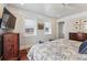 Main bedroom with hardwood floors, a flat-screen TV, and windows with window shades at 99 Tradd St, Charleston, SC 29401