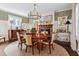 Formal dining room with large table, chandelier, and decorative wallpaper at 99 Tradd St, Charleston, SC 29401