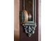 Close-up of an ornate, oval-shaped door knob at 99 Tradd St, Charleston, SC 29401