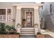 Charming house exterior with a welcoming front porch and landscaping at 99 Tradd St, Charleston, SC 29401