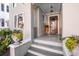Front porch entry with gray painted siding and dark door at 99 Tradd St, Charleston, SC 29401