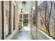 Relaxing front porch with rocking chair and view of a lush courtyard at 99 Tradd St, Charleston, SC 29401