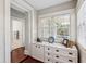 White built-in storage in a hallway with hardwood floors and access to a bathroom at 99 Tradd St, Charleston, SC 29401