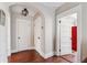 A light-filled hallway with hardwood floors and neutral walls at 99 Tradd St, Charleston, SC 29401