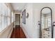 Long hallway with hardwood floors, neutral walls, and large windows at 99 Tradd St, Charleston, SC 29401