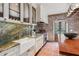 Bright kitchen boasts white cabinets, farmhouse sink, and marble countertops at 99 Tradd St, Charleston, SC 29401