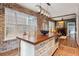 Kitchen island with wood countertop, ample storage, and seating for four at 99 Tradd St, Charleston, SC 29401