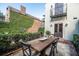 Patio with wooden dining table and chairs at 99 Tradd St, Charleston, SC 29401