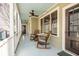 Relaxing front porch with rocking chairs and ceiling fan at 99 Tradd St, Charleston, SC 29401