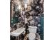 Small powder room with pedestal sink and floral wallpaper at 99 Tradd St, Charleston, SC 29401