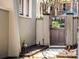 Private side gate entrance with brick wall and stone pathway at 99 Tradd St, Charleston, SC 29401