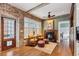 Rustic sitting area with exposed brick and hardwood floors at 99 Tradd St, Charleston, SC 29401