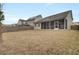 Fenced backyard view of home with screened porch at 9991 Winged Elm St, Ladson, SC 29456