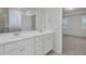 Double vanity bathroom with white cabinets and gray tile at 9991 Winged Elm St, Ladson, SC 29456