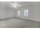 Spacious bedroom with neutral walls, carpeting, and two windows with shutters at 9991 Winged Elm St, Ladson, SC 29456