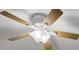 Close-up view of a white ceiling fan with light kit and wood blades at 9991 Winged Elm St, Ladson, SC 29456