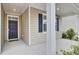 Covered front porch with white columns and a dark-colored front door at 9991 Winged Elm St, Ladson, SC 29456