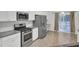 Kitchen boasts stainless steel appliances and granite countertops at 9991 Winged Elm St, Ladson, SC 29456