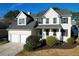 Two-story house with a beige exterior, two-car garage, and landscaping at 109 Historic Dr, Mount Pleasant, SC 29464
