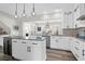 Open kitchen with white cabinetry, granite island, and breakfast area at 109 Historic Dr, Mount Pleasant, SC 29464