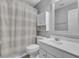 Clean bathroom with white vanity, striped shower curtain, and mirror at 114 Avalon Rd, Summerville, SC 29483