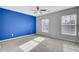 Bedroom with blue accent wall, ceiling fan, and large windows at 114 Avalon Rd, Summerville, SC 29483