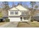 Two-story yellow house with a white garage door and dark shutters at 114 Avalon Rd, Summerville, SC 29483