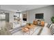 Bright living room with wood-look floors, comfy seating, and a large TV at 114 Avalon Rd, Summerville, SC 29483