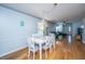 White dining table with chairs, hardwood floor and view of living room and kitchen at 1295 Island Club Dr # E, Charleston, SC 29492