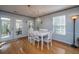 Dining area with white table and chairs, hardwood floors and access to a screened porch at 1295 Island Club Dr # E, Charleston, SC 29492
