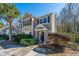 Tan two-story townhome with black shutters and landscaping at 1295 Island Club Dr # E, Charleston, SC 29492