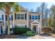 Tan two-story house with dark shutters, landscaping, and a driveway at 1295 Island Club Dr # E, Charleston, SC 29492