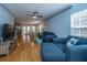 Open living room with hardwood floors, a sectional sofa, and a view of the dining area at 1295 Island Club Dr # E, Charleston, SC 29492