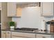 Gas cooktop with decorative hood and modern backsplash at 176 Callibluff Dr, Summerville, SC 29486