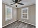 Bright bedroom with grey wood flooring and ceiling fan at 1984 Hugo Ave, North Charleston, SC 29405