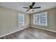 Bright bedroom with grey wood flooring and ceiling fan at 1984 Hugo Ave, North Charleston, SC 29405
