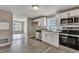 Renovated kitchen with white cabinets and stainless steel appliances at 1984 Hugo Ave, North Charleston, SC 29405