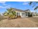 Home's backyard with a screened porch and palm trees at 199 Schooner Bend Ave, Summerville, SC 29486