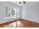 Bedroom with hardwood floors, three windows, and a ceiling fan at 199 Schooner Bend Ave, Summerville, SC 29486