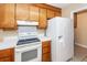 White appliances and wood cabinets in kitchen at 208 Buckskin Dr, Summerville, SC 29486