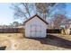 White wooden shed with double doors in the backyard at 208 Buckskin Dr, Summerville, SC 29486
