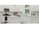 White kitchen with gas range and island at 216 Pine Crest View Dr, Summerville, SC 29486