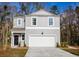 Two-story gray house with white garage door and landscaping at 223 Pine Crest View Dr, Summerville, SC 29486