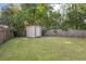 Fenced backyard with lush lawn and a storage shed at 2236 Bailey Dr, North Charleston, SC 29405